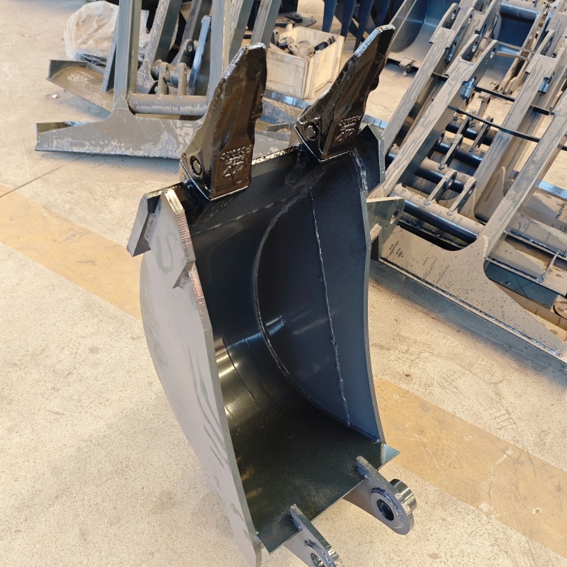 Small excavator equipped with loading attachments - log grab, small bucket, narrow bucket