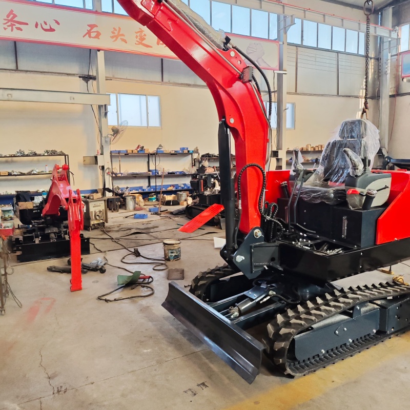 Small excavator equipped with loading attachments - log grab, small bucket, narrow bucket