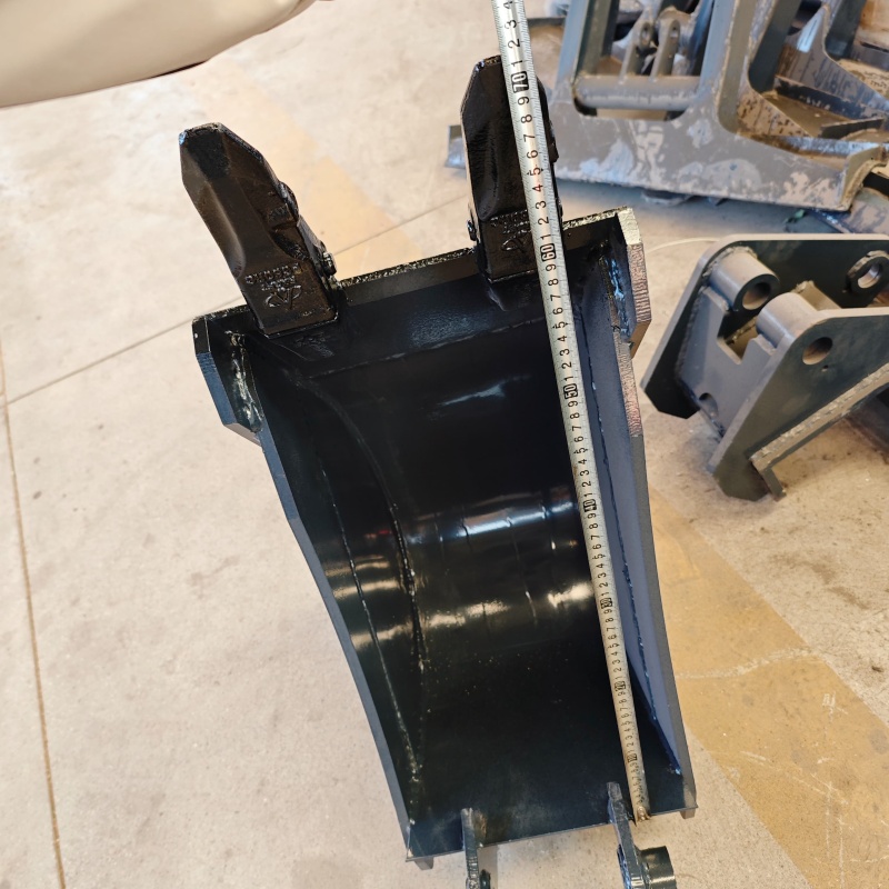 Small excavator equipped with loading attachments - log grab, small bucket, narrow bucket