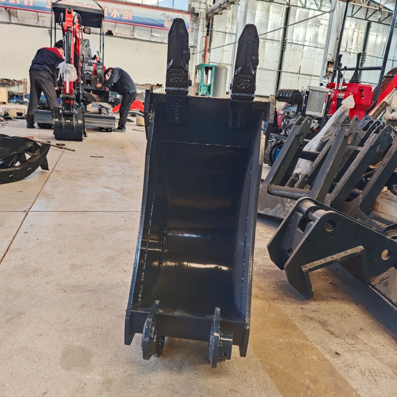 Small excavator equipped with loading attachments - log grab, small bucket, narrow bucket