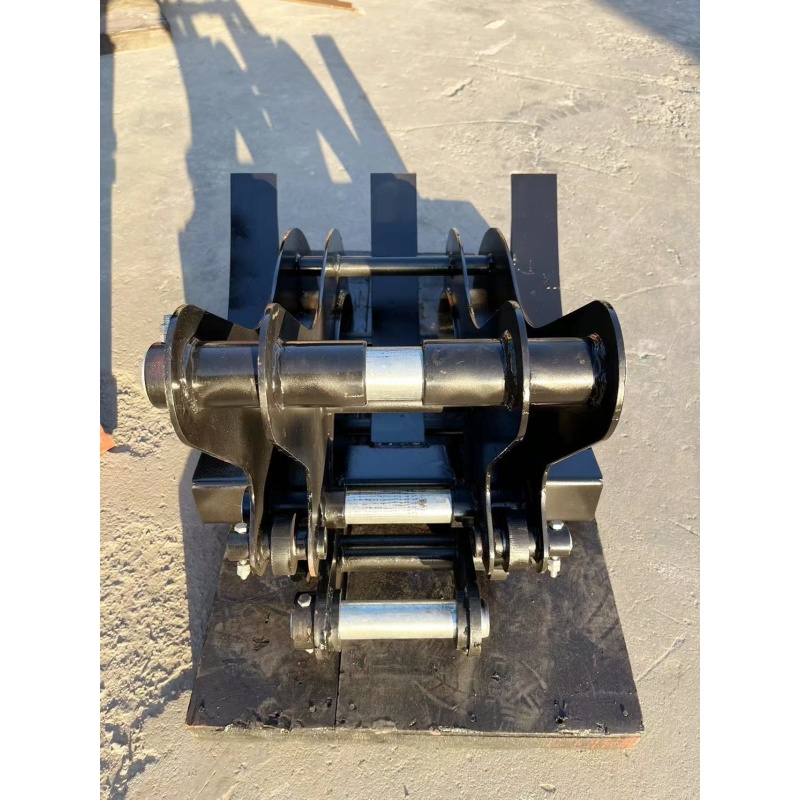 Small excavator equipped with loading attachments - log grab, small bucket, narrow bucket