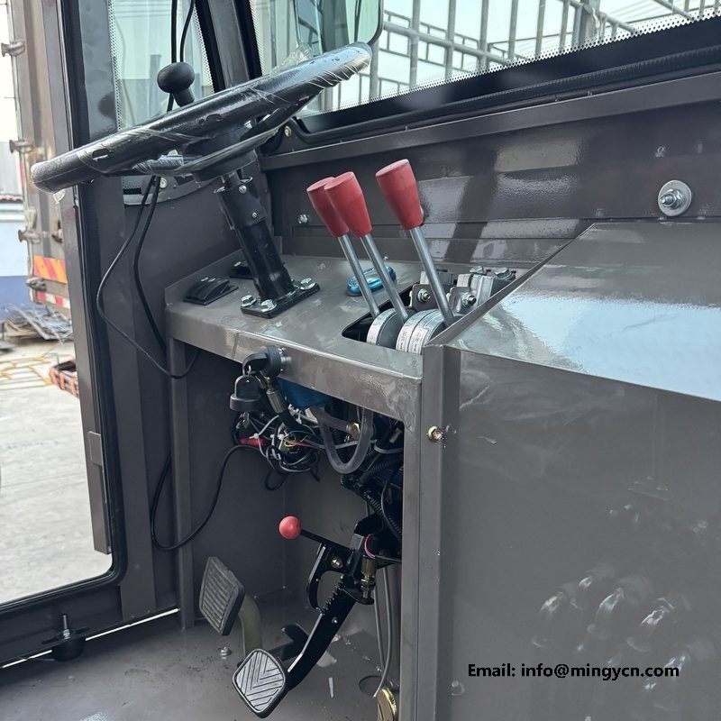 operator control station inside the cab with twin red hydraulic levers and pedals